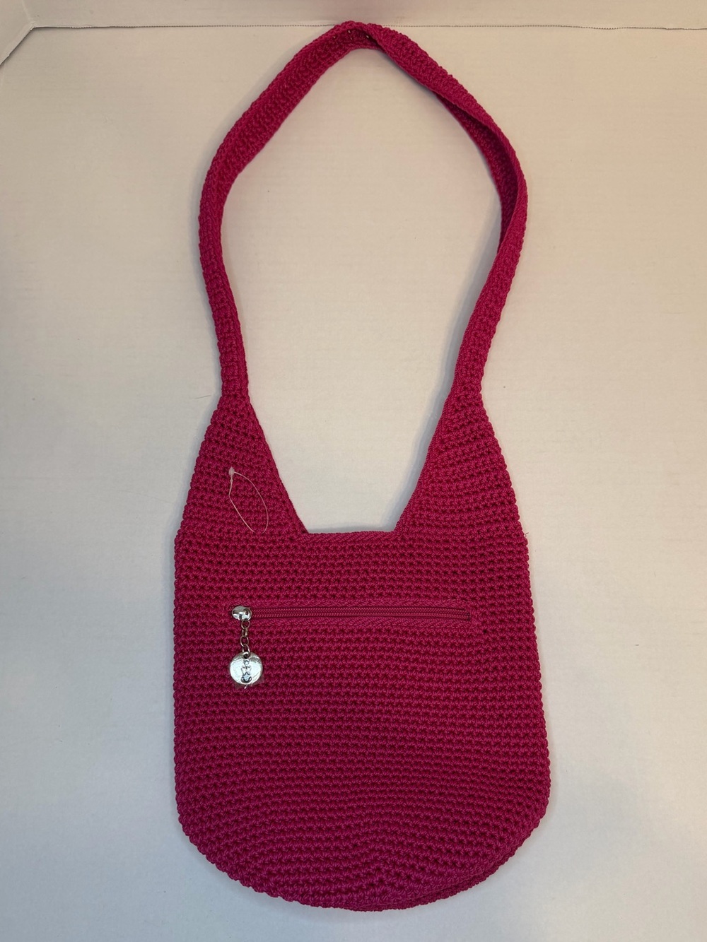 The Sak raspberry, pink handcrafted crochet hobo shoulder bag